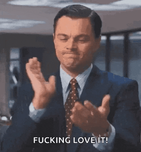 a man in a suit and tie is clapping his hands and saying ■■■■■■■ love it !